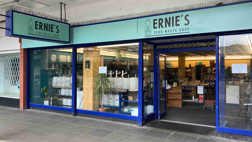 A shop with a sign saying Ernie's Zero Waste Shop above the door in black on turquoise