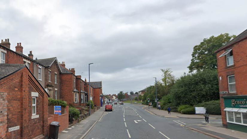Newtown Road in Carlisle. Is it a wide street with red brick terraced houses on the left-hand side of the road, facing a park.
