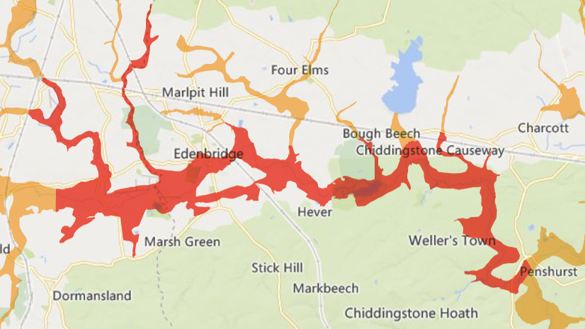 A map with red overlay showing areas in east Surrey and west Kent which are at risk of flooding.