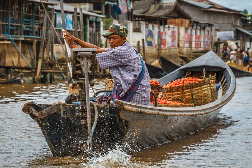 Man transports his goods on a river