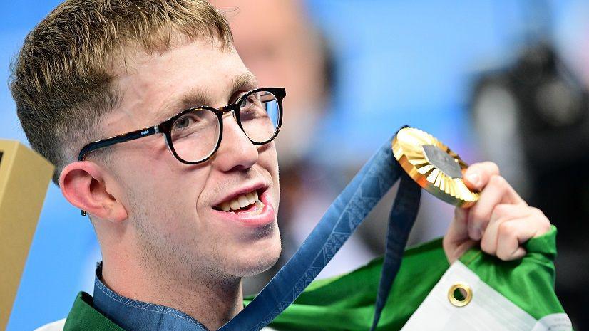 Dan Wiffen holding his medal