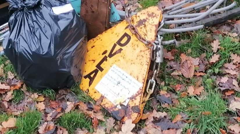 A rusty DVLA clamp dumped by the side of the road 