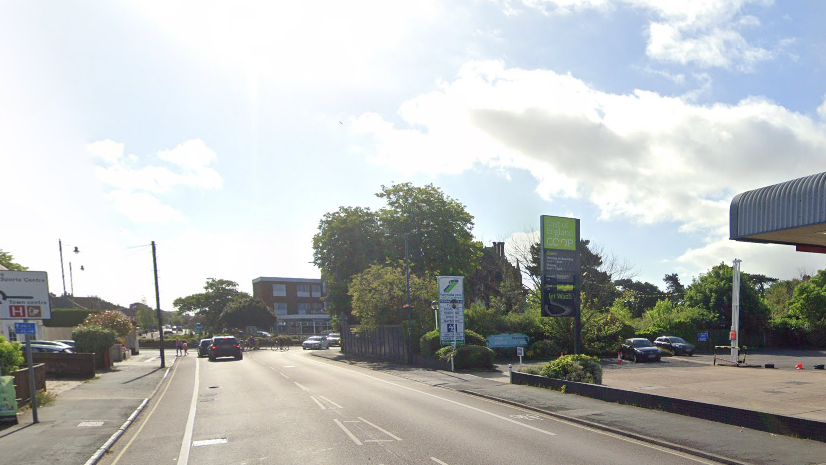 A general view of High Road West in Felixstowe. It shows a road leading up to a roundabout with a petrol station to the right. Cars can be seen travelling along the road.