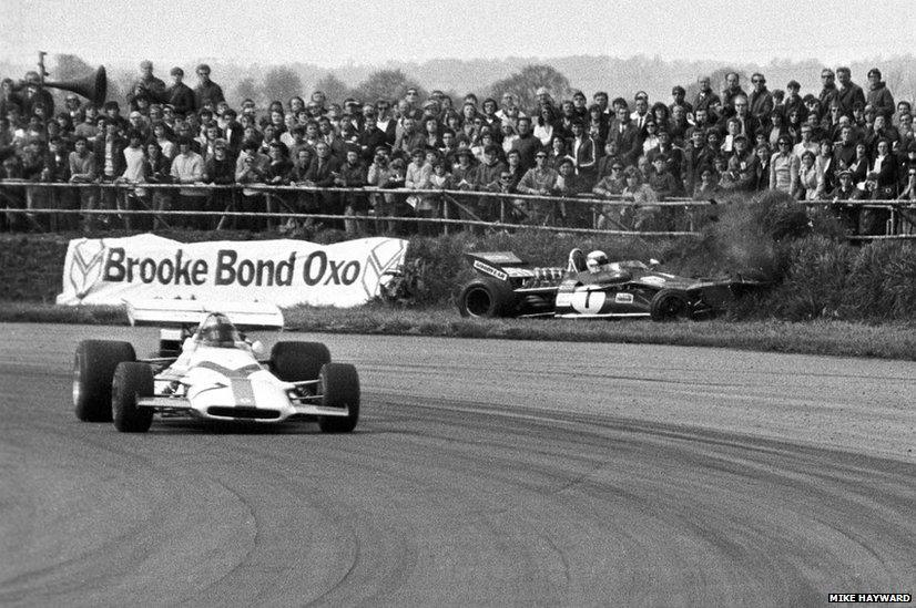 Jackie Stewart's Tyrrell 003 hits the earth bank on the outside of Copse Corner, Silverstone