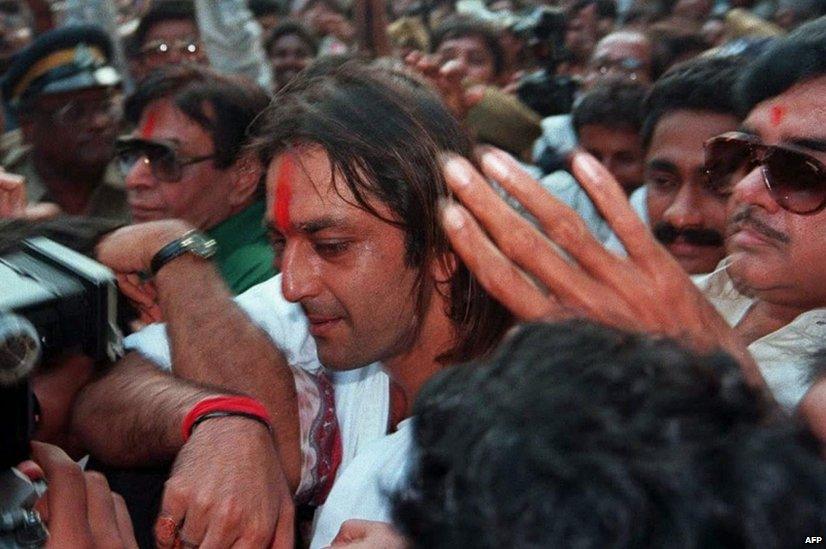 In this photograph taken on October 17, 1995, Indian Bollywood actor Sanjay Dutt (C) is mobbed by fans as he walks out of the high-security Arthur Road Jail in Mumbai, after his release on bail following bomb attacks on the western Indian city in 1993