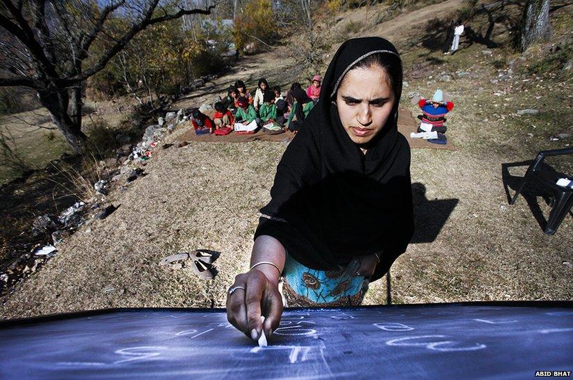 Saima Chalkoo, teaches children of a primary school in the open near the Line of Control, in Silikote village, some 125 km north of Srinagar.