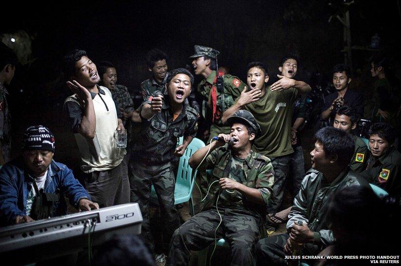 Kachin Independence Army fighters drinking and celebrating at a funeral