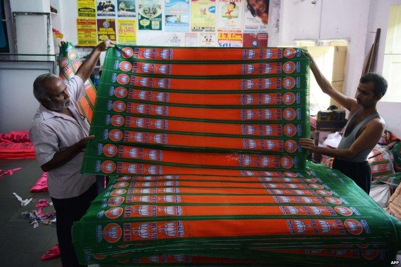 Indian workers make BJP campaign flags at a workshop in Hyderabad.