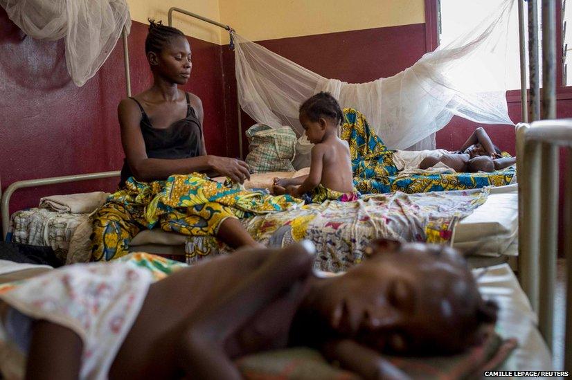 A mother tends to her child who is suffering from malnutrition at a paediatrics hospital in Bangui, Central African Republic