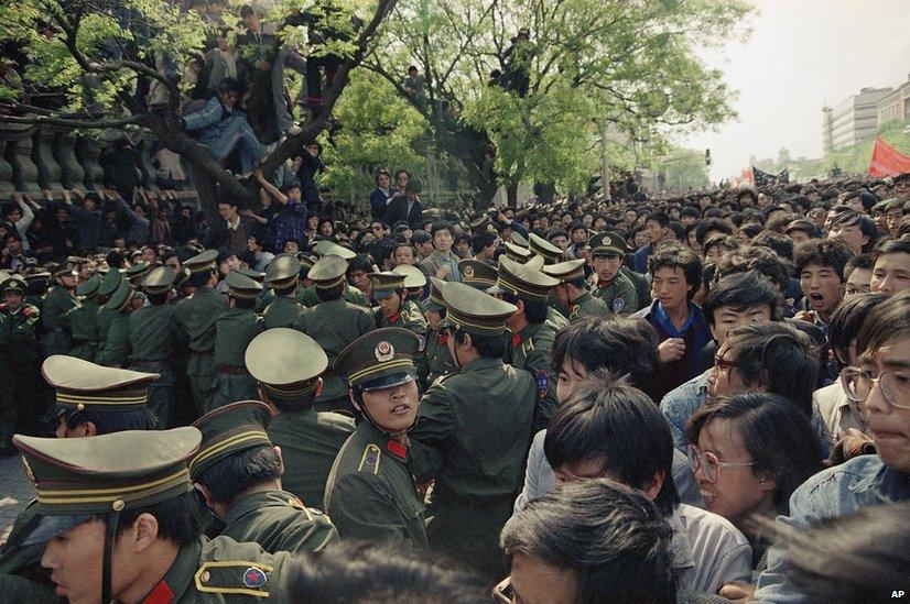 Students demonstrators scuffle with police while trying to reach Tiananmen Square on 27 April 1989