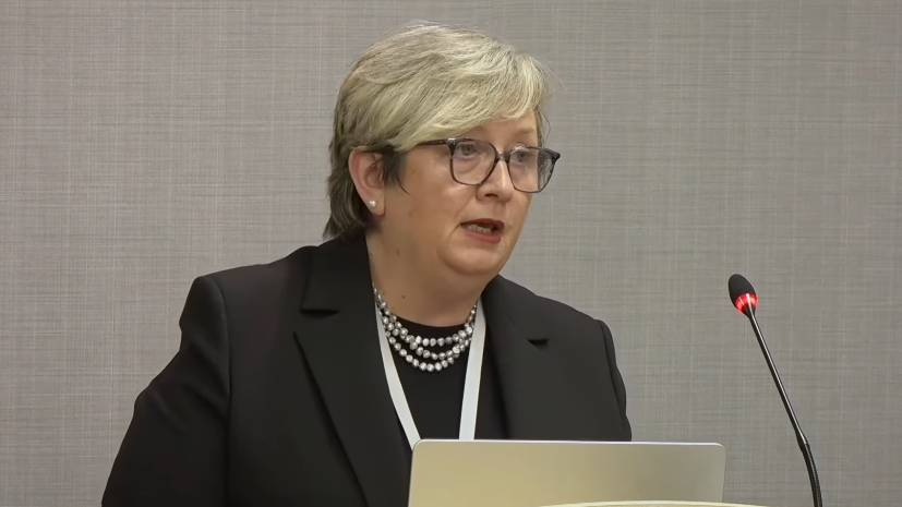 Joanna Cherry KC, a woman in her late 50s with short blonde hair and glasses speaks into a microphone. She is wearing a black jacket with pearls.