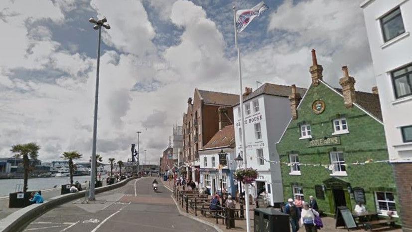 Poole Quay with the harbour on the left and historical buildings on the right