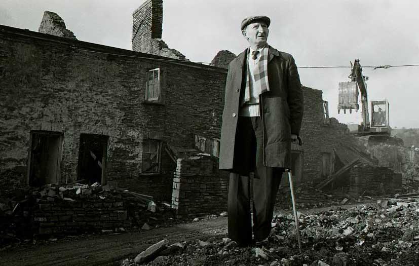 Mr Coles' home is demolished as he looks on in 1983 - he had lived in the miners cottage at The Ranks in Abercarn, Caerphilly, all of his life