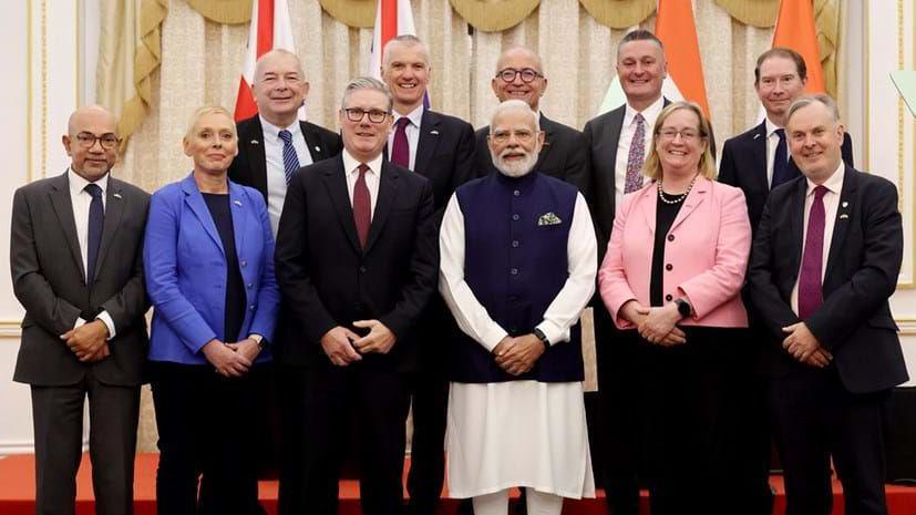 Official group portrait showing UK prime minister Keir Starmer and Indian Prime Minister Narendra Modi with nine other people representing the UK education sector. They are lined up on two rows with Prof Simon Guy on the front right