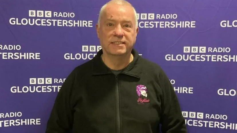 Nick Gazzard stood in front of BBC Gloucestershire's purple screen.