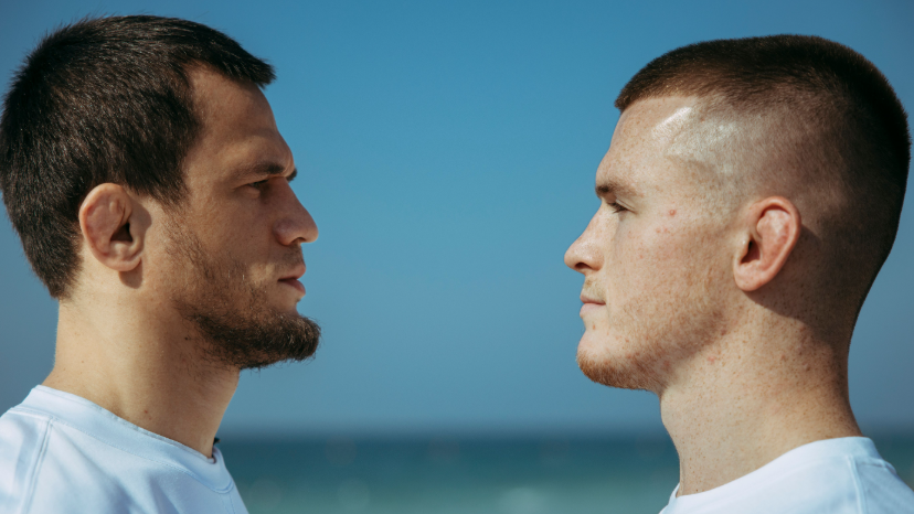 Usman Nurmagomedov faces off with Paul Hughes with the sea behind them