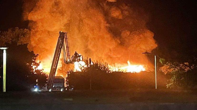 Aerial ladder being used to fight a fire