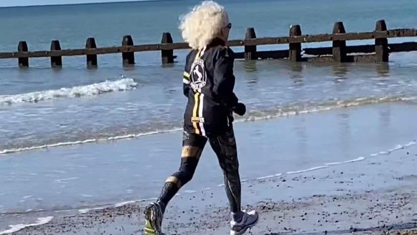 Daphne Belt running on the beach near her home in Littlehampton, West Sussex