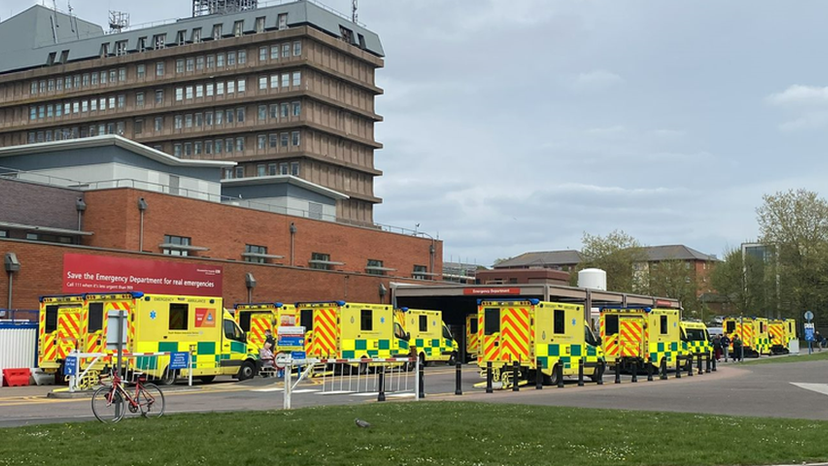 Around nine ambulances are seen queuing up outside the A&E department at Gloucestershire Royal Hospital on a clear day