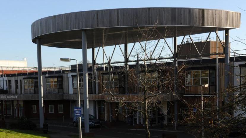 Exterior of the hospital with a domed roof over the entrance.