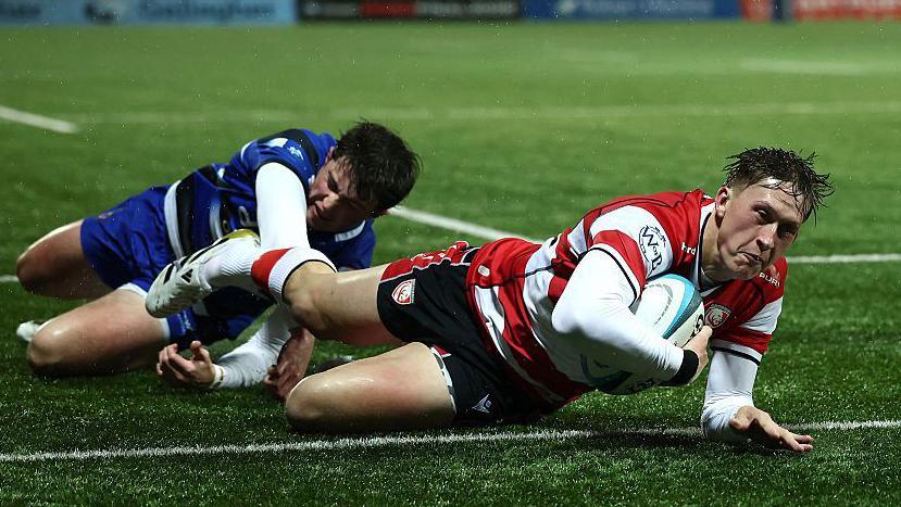 Gloucester wing Josh Hathaway dives over to score a try.