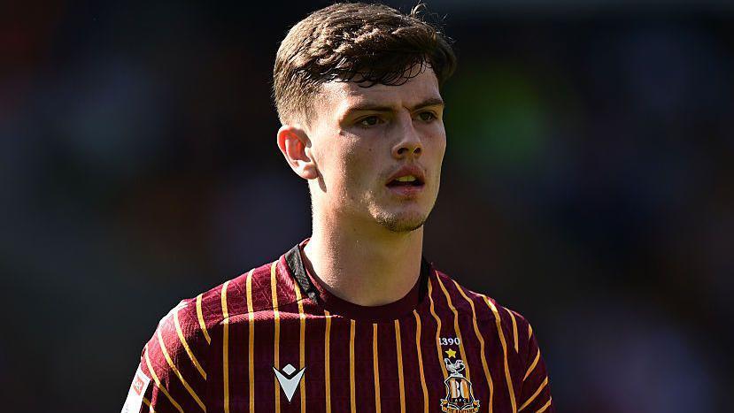 Jason Metcalfe looks on in a Bradford City home shirt