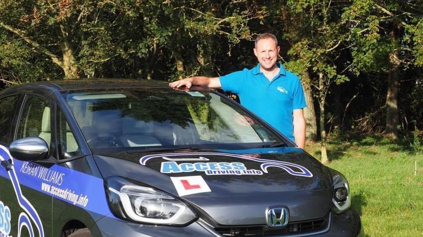 Keiran Williams standing next to a car