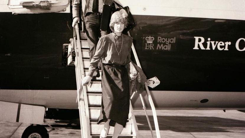 Princess Diana in a blouse and skirt steps down from a plane at the airport 