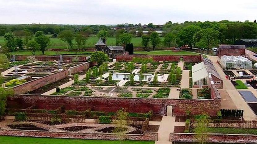 RHS Garden Bridgewater - a series of paths surrounded by trees and ornately laid out gardens.