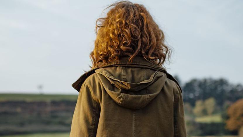 A woman staring into the distance