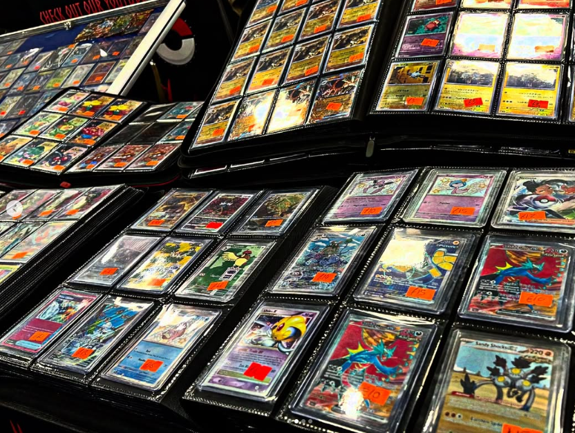 Books of colourful trading cards on a table together.