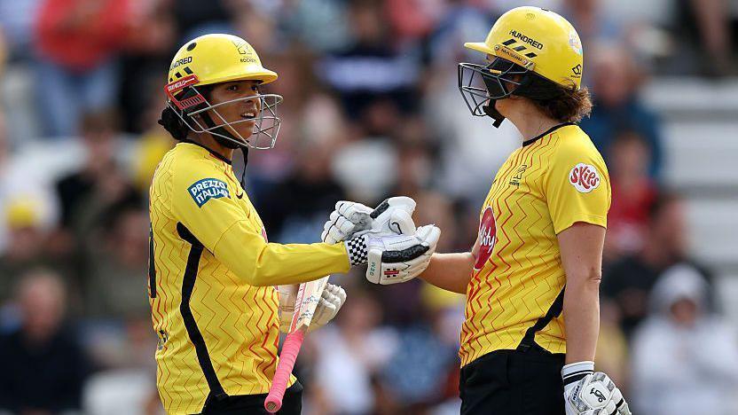 Sophia Dunkley and Nat Sciver-Brunt bump fists while batting for Trent Rockets