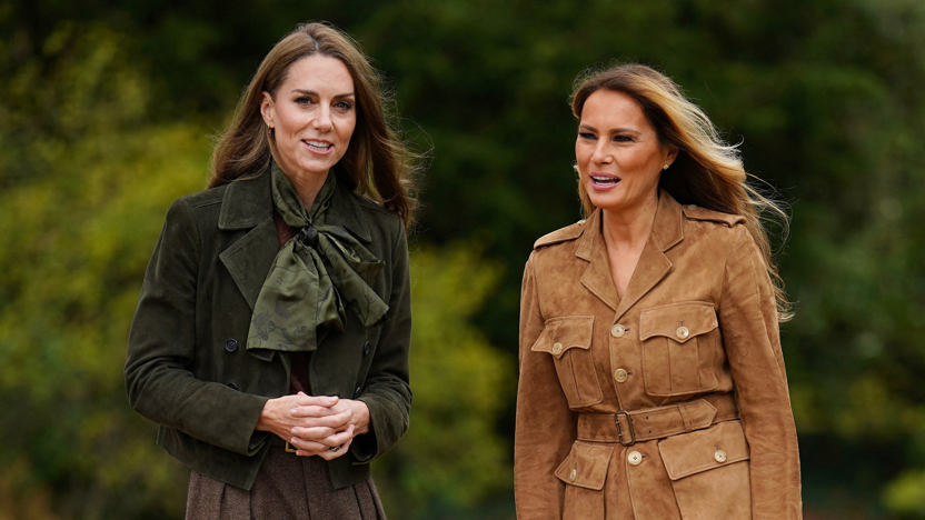 The Princess of Wales - wearing a green jacket and scarf - and the First Lady of the US- wearing a brown jacket - walking side by side 