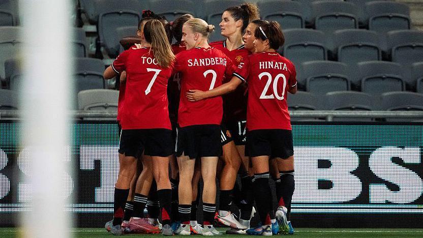 Elisabeth Terland of Manchester United celebrates scoring her teams first goal with team-mates