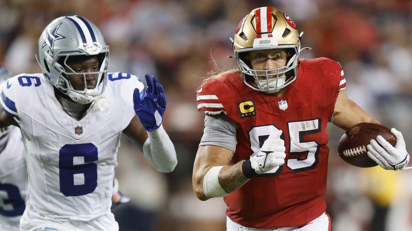 George Kittle of nan San Francisco 49ers runs pinch nan shot aft a drawback against nan Dallas Cowboys successful October 2024