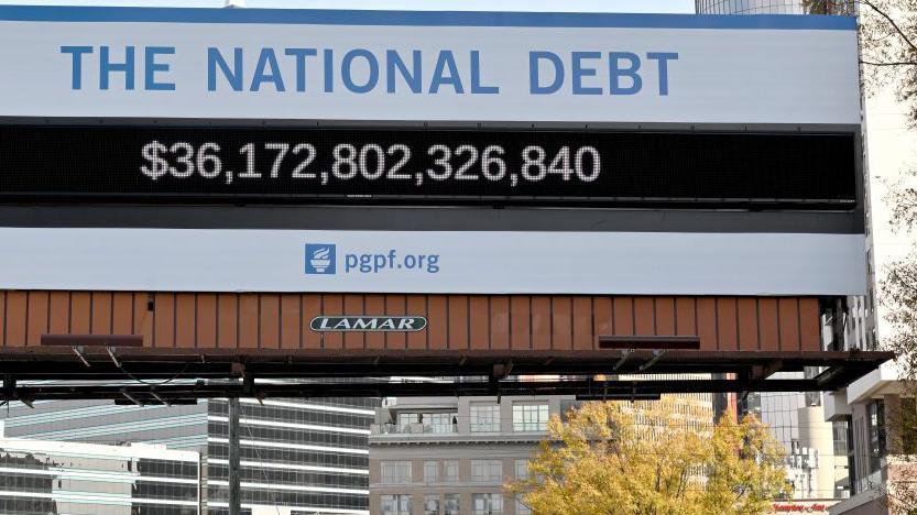 A poster and electronic billboard in Atlanta that displays the current US  debt per person and as a nation at 36 Trillion dollars on 04 December 