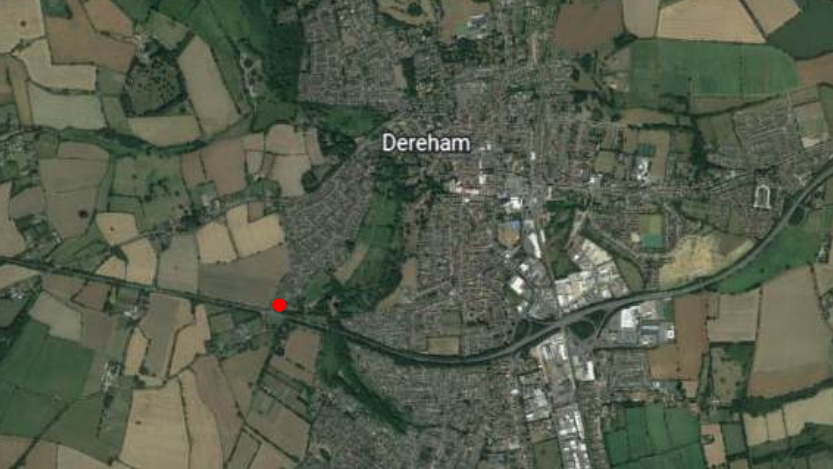 We can see an overhead satellite map of Dereham. To the south-western side of the town a red dot indicates where the home would be built.