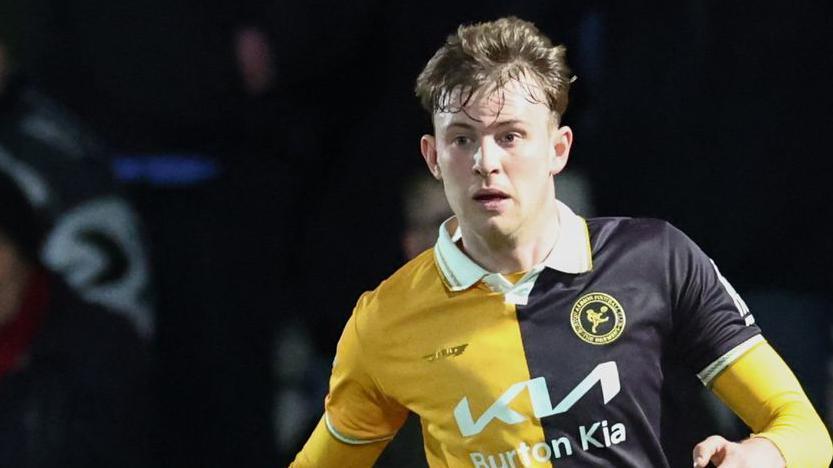 JJ McKiernan playing for Burton Albion in a gold and black shirt