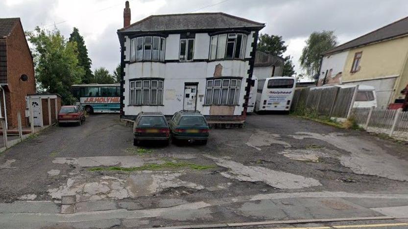 Photo from three years ago of 158 Cannock Road, including coaches