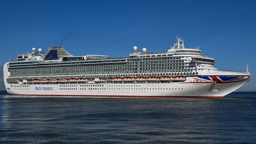 Ventura - a large cruise ship with a union flag painted on the side. It is at sea.