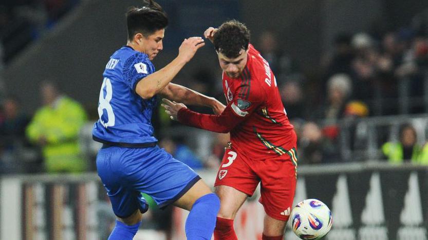 Dastan Satpaev (left) in action for Kazakhstan against Wales