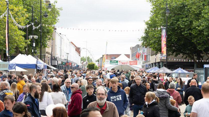 A crowd moving between stalls at the Bolton Food and Drink Festival