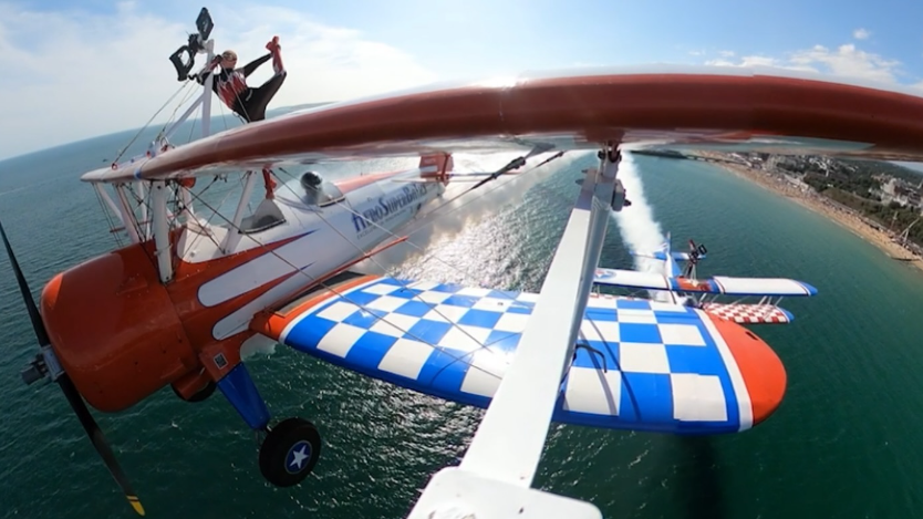 Wing-walkers performing on two bi-planes over a body of water