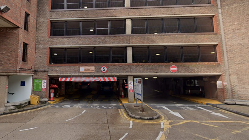 The entrance to the Ashley Centre car park in Epsom viewed from street level.