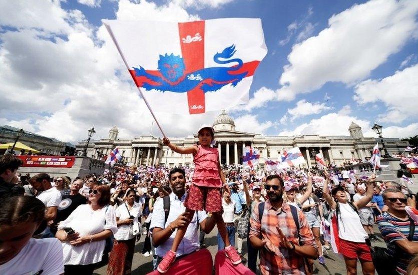 Little girl waving England flag.