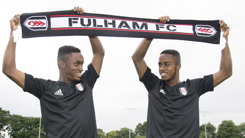 Ryan, right, and Steven Sessegnon pose for photos, holding up a Fulham scarf, after signing their first professional contracts with the club in 2017