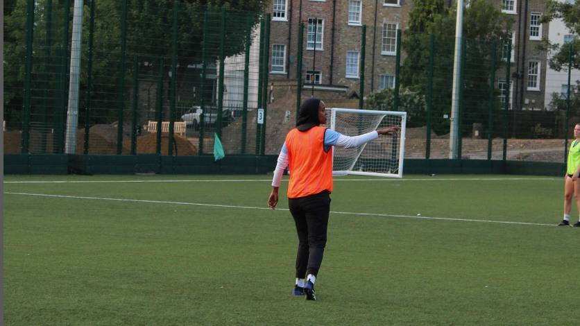 Iqra Ismail playing football on a pitch