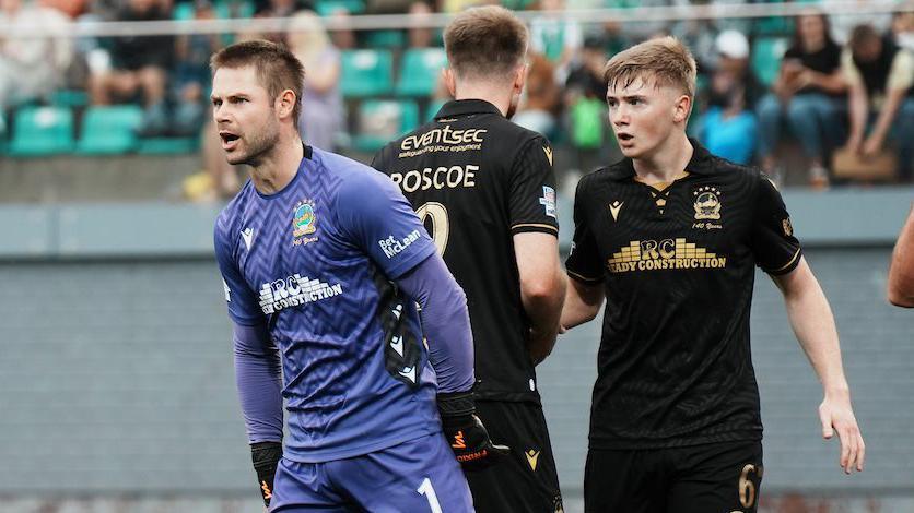 Linfield goalkeeper Chris Johns with team-mates during the game at the LFF Stadium