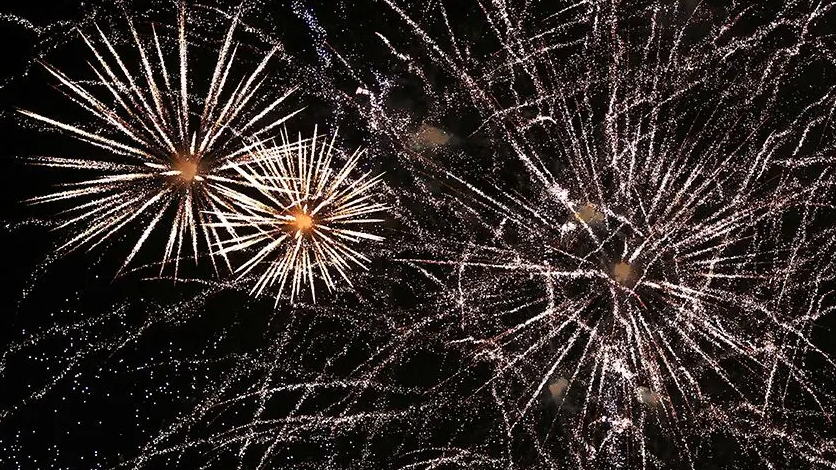 Exploding fireworks fill the night sky