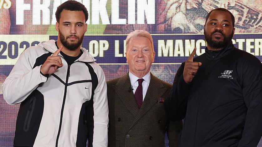 Moses Itauma stands next to Frank Warren and Jermaine Franklin at a news conference